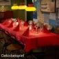 Festlich gedeckter Tisch mit roter Tischdecke und gefalteten Servietten Shimmer Trees von Duni.