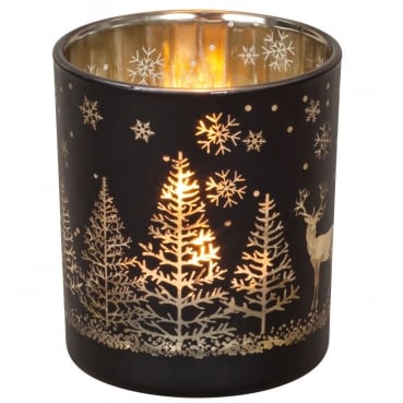 Teelichtglas Winterwald mit Hirsch in Schwarz/Gold verspiegelt, 78 mm, mit angezündetem Teelicht.