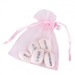 Gastgeschenk Organzasäckchen mit Gefühlssteinen und Schnuller in Rosa